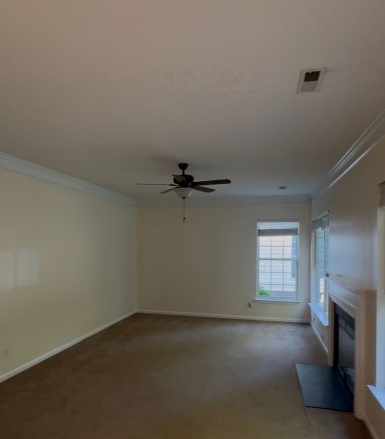 Living room before — a single ceiling-fan light on an empty ceiling